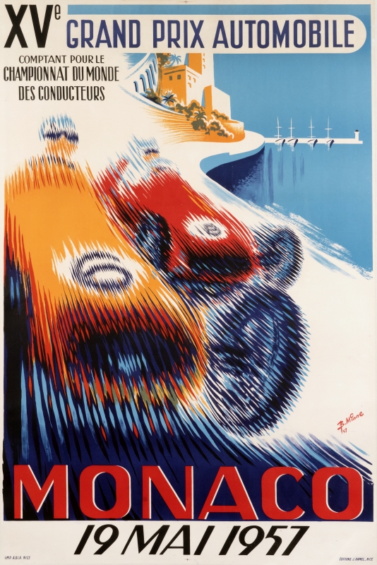 Cars race down speedway, coastline on their right; red, blue, orange, white